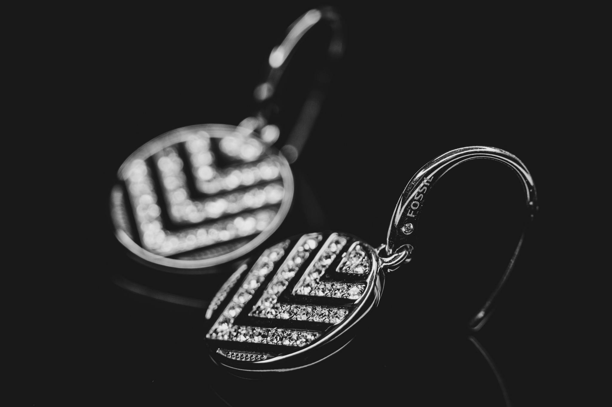 Close-up view of elegant diamond earrings with a chevron design on a black background.