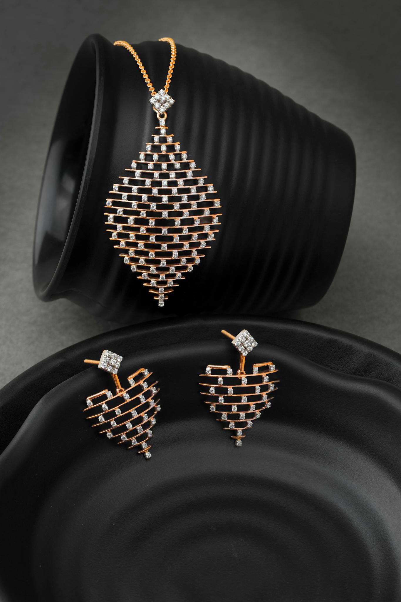 Luxurious diamond necklace and earrings displayed against a black background, showcasing elegance.
